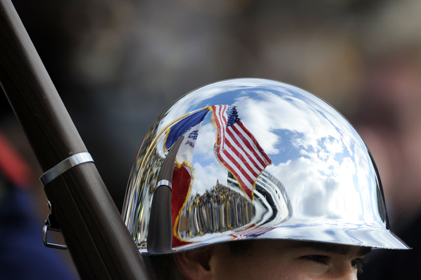 The American Flag is reflected off the helmet of a member of the color guard before a football game between IU and Iowa on Saturday, Oct. 31, 2009, in Iowa City, Iowa.