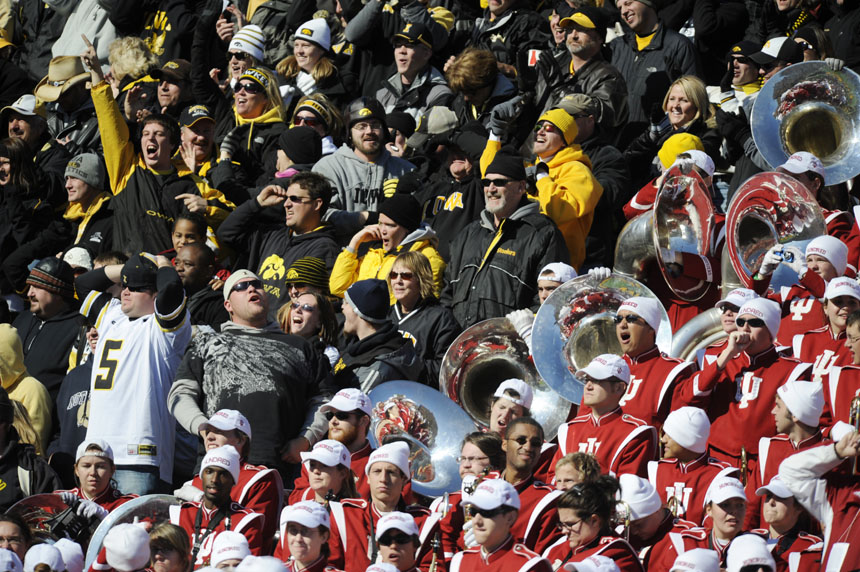 Iowa fans cheer after a touchdown as the IU Marching Hundred, at right, look on during a football game on Saturday, Oct. 31, 2009, in Iowa City, Iowa.