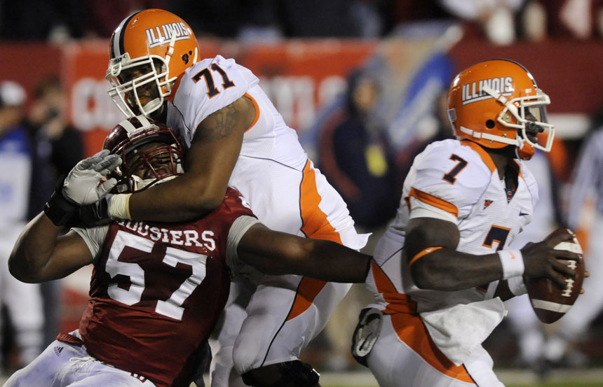 IU defensive end Jammie Kirlew (57) struggles in an attempt to sack Illinois quarterback Juice Williams during a football game on Saturday, Oct. 17, 2009, at Memorial Stadium. Illinois offensive lineman Jeff Allen (71) was called for holding on the play.