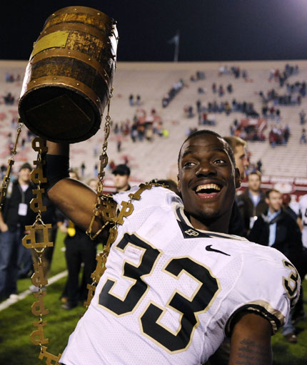 Purdue running back Jaycen Taylor celebrates with the Old Oaken Bucket after the Boilermakers defeated IU 38-21 on Saturday, Nov. 21, 2009, at Memorial Stadium.