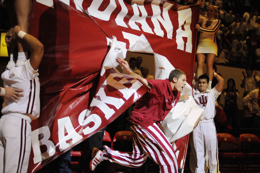 Indiana forward Derek Elston busts out of an IU banner leading his team onto the court before a game against Maryland on Tuesday, Dec. 1, 2009, at Assembly Hall in Bloomington, Ind.