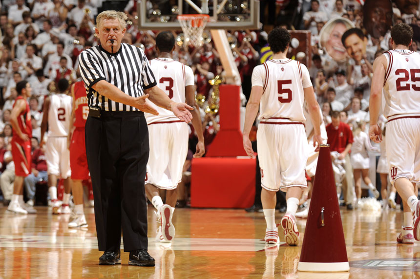 An official points to a cheerleader's megaphone after the squad left it on the floor after a timeout during a game between IU and Maryland on Tuesday, Dec. 1, 2009, at Assembly Hall in Bloomington, Ind. Maryland won 80-68.