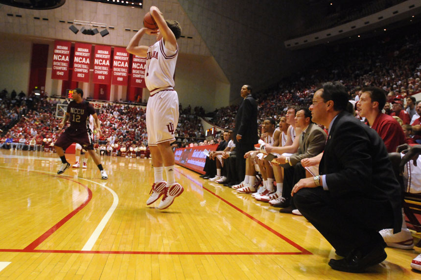 IU coach Tom Crean, right, watches  as guard Jordan Hulls shoots a three pointer from the corner during a game on Saturday, Dec. 19, 2009, at Assembly Hall. IU won 81-58.
