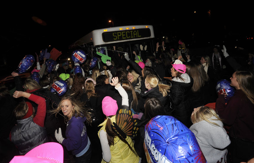 Alpha Chi Omega members swarm a bus as new members are welcomed to the house during Bid Day on Monday, Jan. 11, 2010, outside the chapter's Jordan Avenue house.