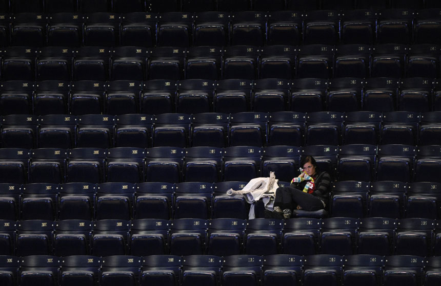 A lone fan watches the action from an empty section during a NCAA women's basketball game between IU and Illinois on Thursday, Jan. 7, 2010, at Assembly Hall. Bad weather and Christmas break contributed to an extremely sparse crowd at the game although the official attendance was listed at 1,350.