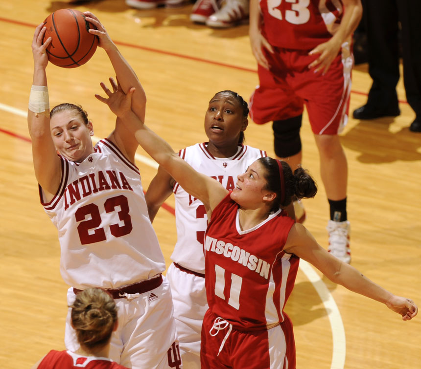 Indiana guard Jamie Braun (23) grabs a rebound away from a Wisconsin guard Rae Lin D'Alie defender during a game on Thursday, Jan. 28, 2010, at Assembly Hall.