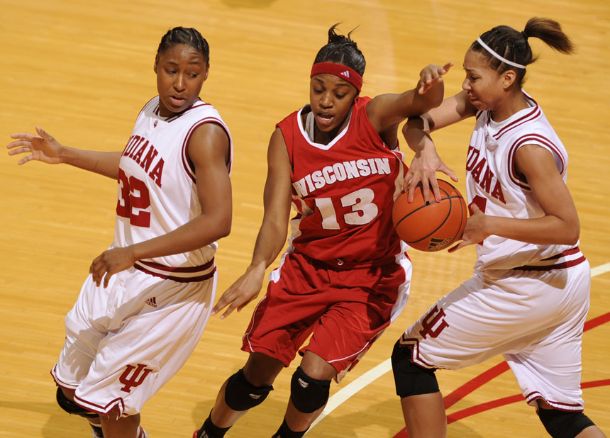 Wisconsin guard Teah Gant (13) disrupts a pass by positioning between Indiana guard Jori Davis (32) and forward Hope Elam during a game on Thursday, Jan. 28, 2010, at Assembly Hall.