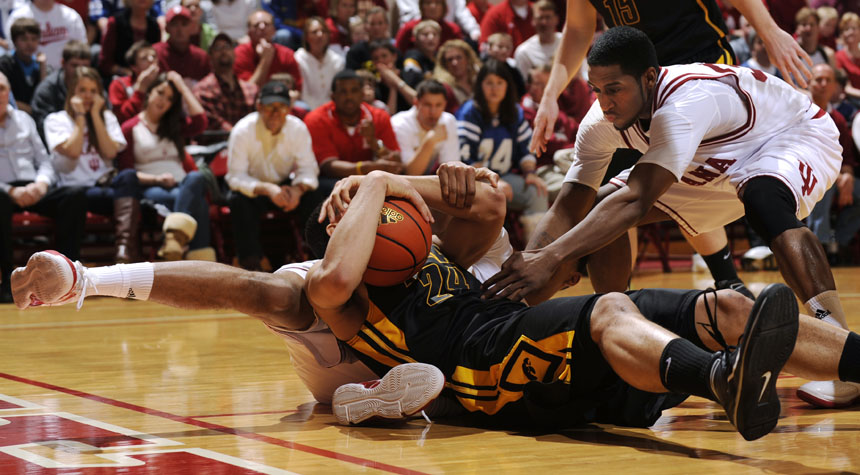 Indiana guard Devan Dumes (33) looks to grab a ball away from Iowa forward Aaron Fuller during a scramble in a game on Sunday, Jan. 24, 2010, at Assembly Hall in Bloomington, Ind.