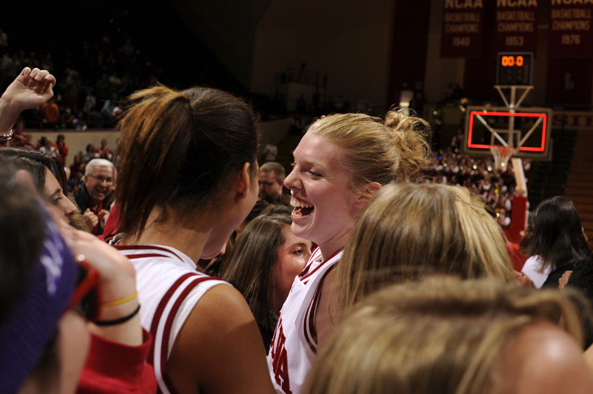 Indiana forward Aulani Sinclair celebrates with fans on the court after IU upset No. 4 Ohio State in a game on Sunday, Jan. 31, 2010, at Assembly Hall. IU won 67-62.