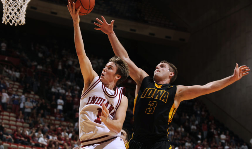 Indiana guard Jordan Hulls lays in a shot off of a fast break as Iowa guard Cully Payne (3) looks to block it from behind during a game on Sunday, Jan. 24, 2010, at Assembly Hall in Bloomington, Ind.