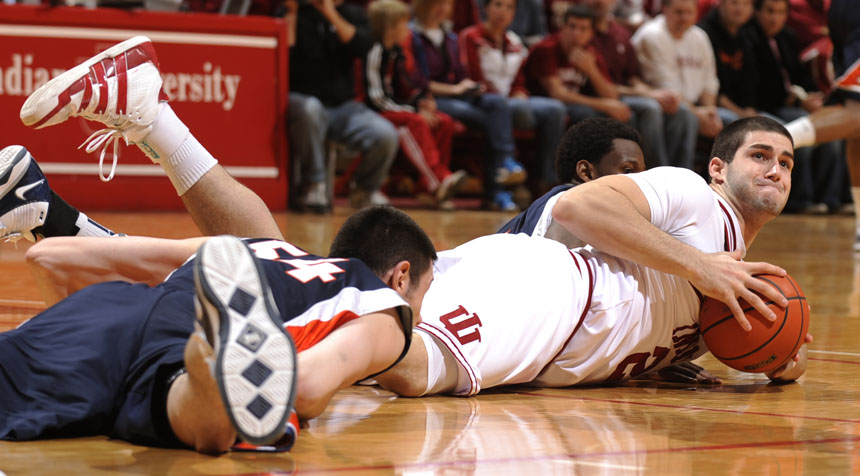 IU forward Bobby Capobianco, right, struggles to grab a loose ball on the floor during a game on Saturday, Jan. 9, 2010, at Assembly Hall. IU lost 66-60.