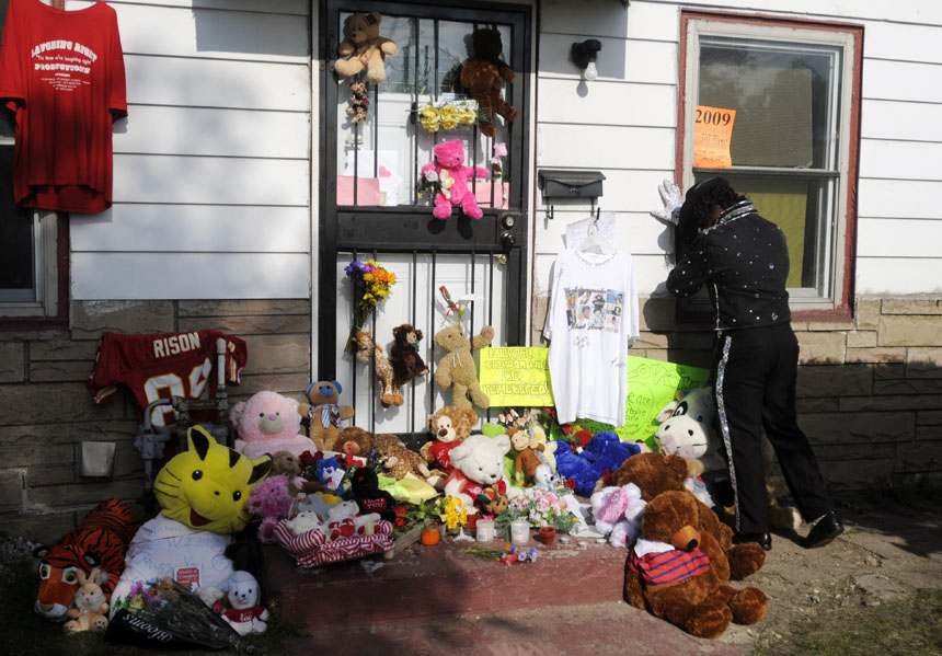 Impersonator Anthony Wilson, of Calumet Park, Ill., pauses for a moment to mourn on Friday, June 26, 2009, in front of Michael Jackson's childhood home in Gary, Ind. The pop star died on Thursday in Los Angeles.
