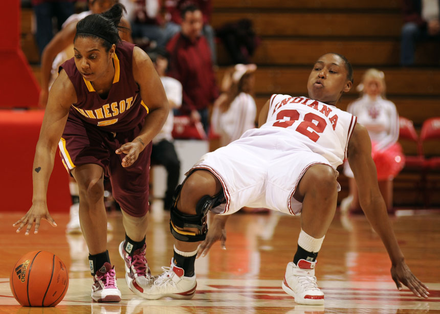IU guard Jori Davis, right, falls to the floor after making contact with Minnesota guard China Antoine during a game on Sunday, Feb. 21, 2010, at Assembly Hall.