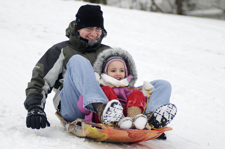 Bianka Hafen, 5, sleds down a hill with her dad and IU student Tyler Hafen on Saturday, Feb. 6, 2010, in Bryan Park. Snow from a winter storm blasted much of Indiana on Friday evening.