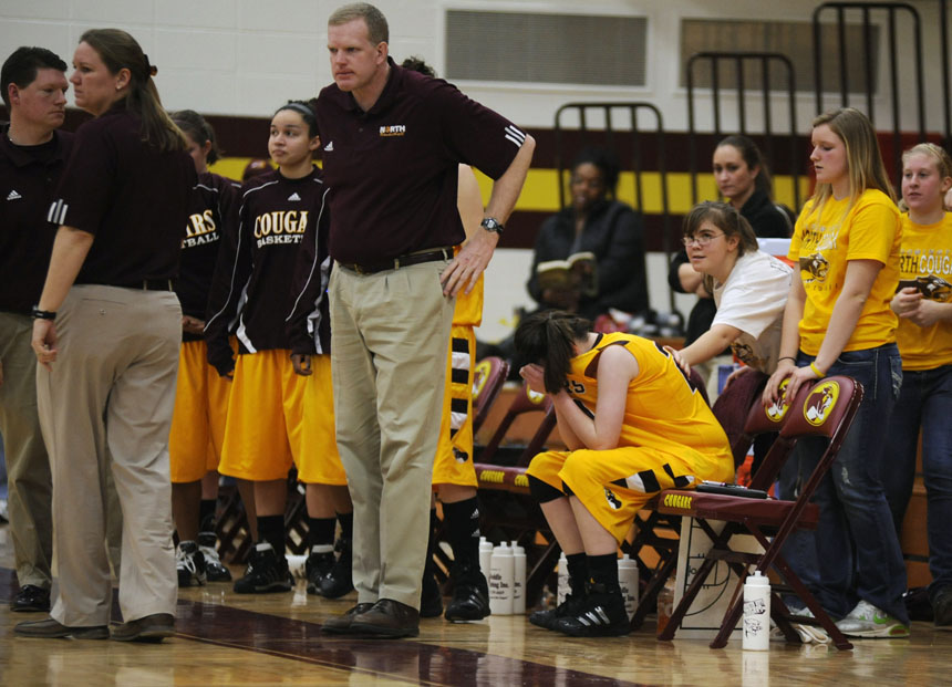 North's Maureen Hirt puts her head in her hands after going to the bench in the final seconds of her team's 45-32 loss to South during a 4A sectional championship game on Tuesday, Feb. 16, 2010, at Bloomington North.