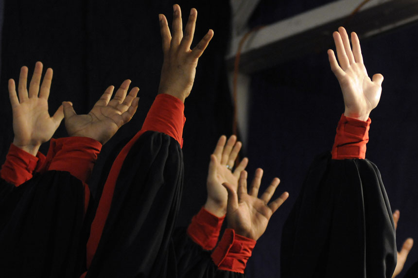 Members of the IU African American Chord Ensemble hold their hands in the air after performing an encore for the audience at the 16th Annual Soup Bowl on Sunday, Feb. 21, 2010, at the Bloomington Convention Center.