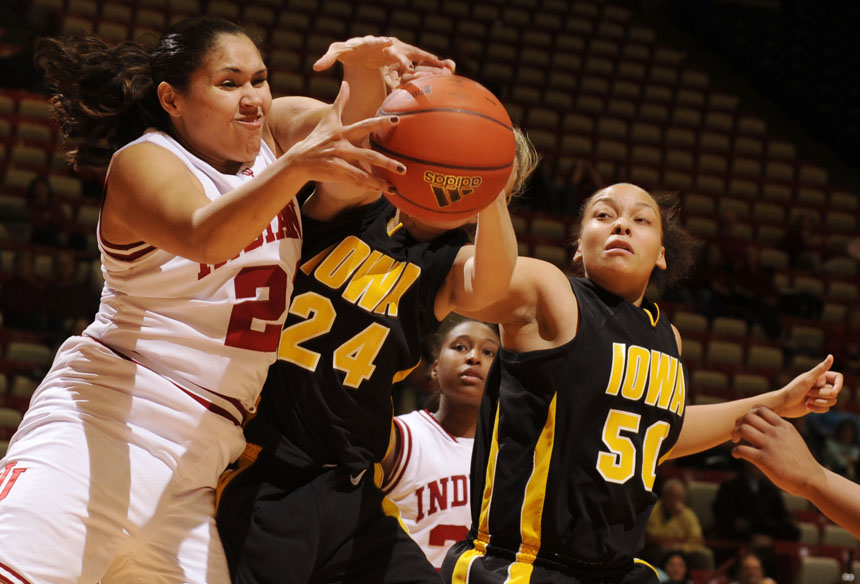 Indiana forward Danilsa Andujar, left, struggles to grab a rebound against Iowa guard Jaime Printy (24) and forward Gabby Machado (50) during a game on Thursday, Feb. 11, 2010, at Assembly Hall. IU was out rebounded 53-29 in the 71-67 loss.