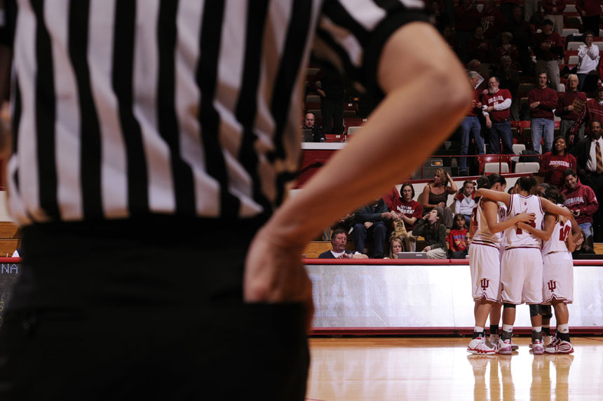An official waits to toss the opening tip as  the IU team huddles on the court before a game against Iowa on Thursday, Feb. 11, 2010, at Assembly Hall.