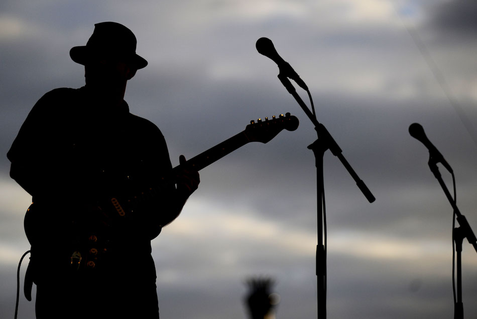 The silhouette of Big Silver Derailed guitarist Sean Ward is seen during the band's performance at the Illinois Blues Festival on Friday, Sept. 3, 2010, at the Riverfront.