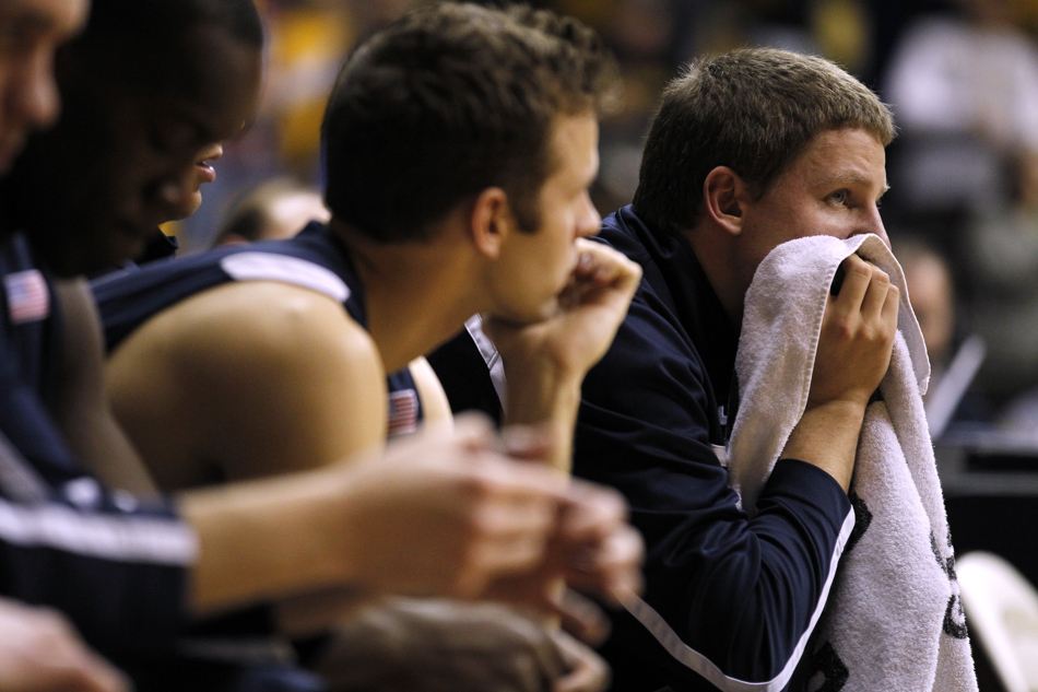 BYU guard/forward Brock Zylstra, right, watches in disbelief from the bench as the team trails Wyoming during the first half of a game on Tuesday, Feb. 2, 2011, in Laramie, Wyo. BYU won 69-62.