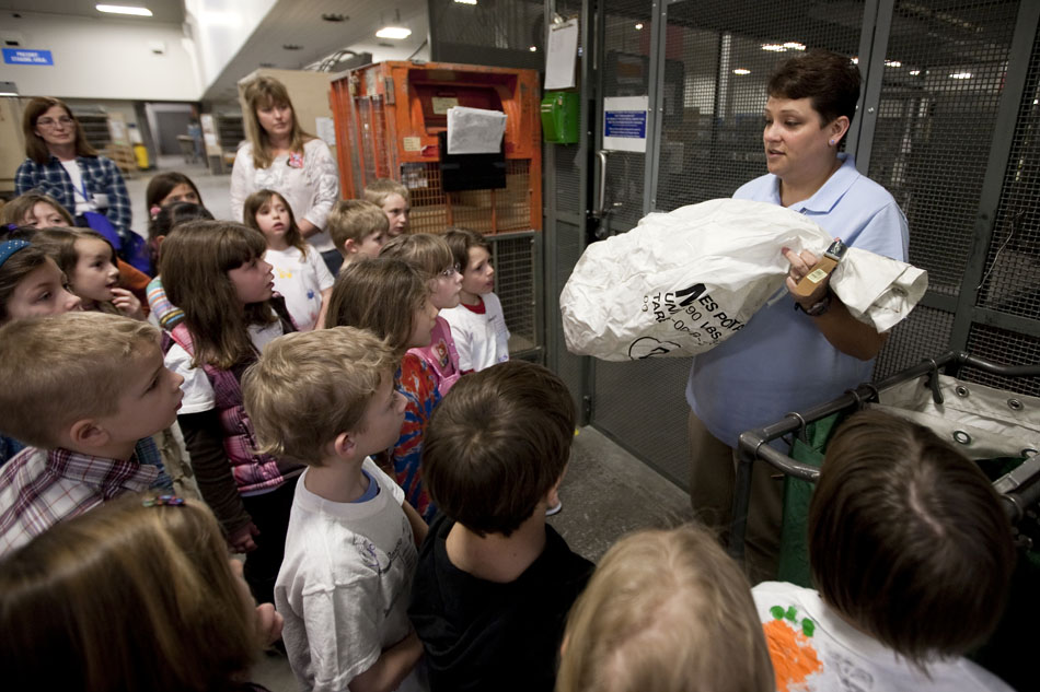 Lynette Tafoya, a clerk at the Cheyenne U.S. Post Office, shows a registered mail bag to youngsters as she gives a tour of the Converse Avenue facility to more than 30 first graders from Buffalo Ridge Elementary on Wednesday, Feb. 9, 2011, in Cheyenne.
