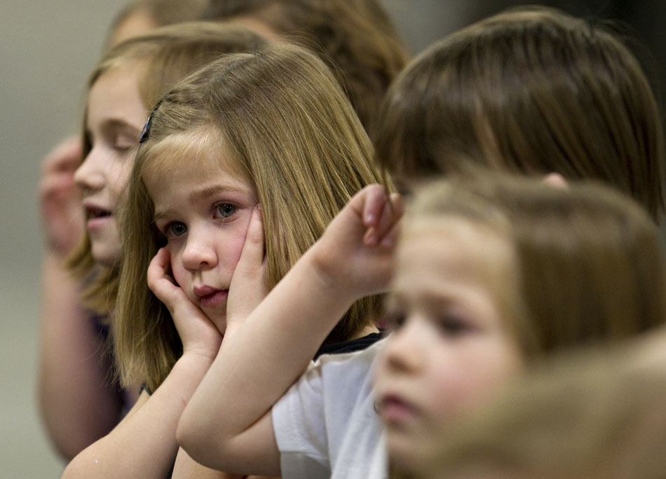 Kensie Summers, a first grader at Buffalo Ridge Elementary, covers her ears in anticipation of a noise from a machine that automatically sorts mail as she and her fellow classmates tour the U.S. Post Office on Converse Avenue on Wednesday, Feb. 9, 2011, in Cheyenne.