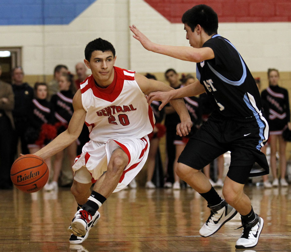 Central's Matt Munoz takes the ball up the court against East's Cameron Jaure during a game on Saturday, Feb. 12, 2011, at Storey Gym in Cheyenne. East won 64-43.