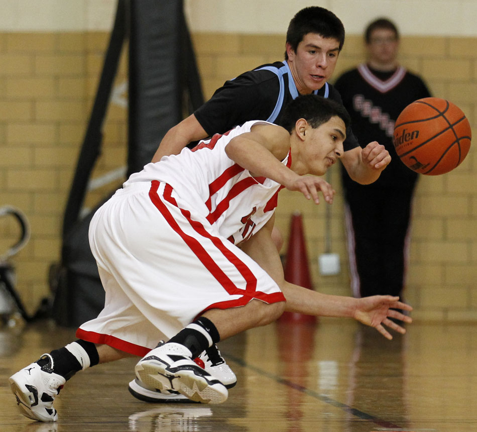 Central's Matt Munoz looses the handle on the ball as he attempts to pass in front of East's Cameron Jaure during a game on Saturday, Feb. 12, 2011, at Storey Gym in Cheyenne. East won 64-43.