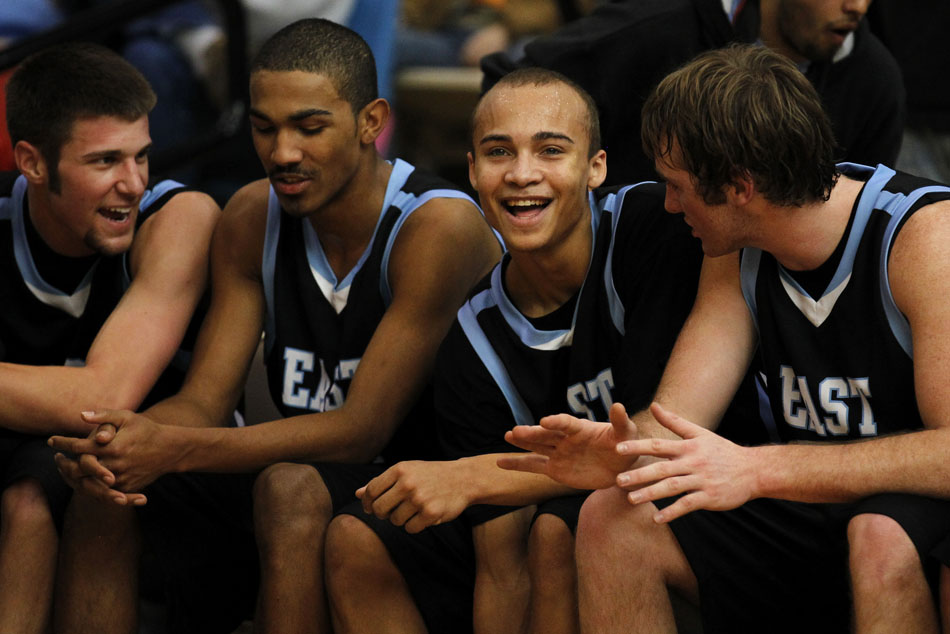 East's Derek Graves, second from right, shares a laugh with teammates after he was subbed out of a blow-out win over Central on Saturday, Feb. 12, 2011, at Storey Gym in Cheyenne. East won 64-43.