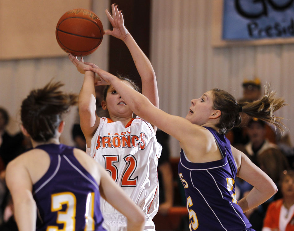 Pine Bluffs' Conner Graves, right, blocks a shot from Burns' Bailey Ward (52) during a girl's basketball game on Saturday, Feb. 19, 2011, at Burns High School.