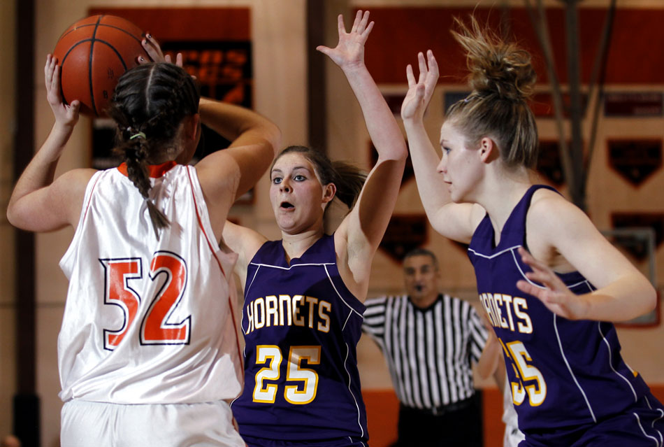 Pine Bluffs' Conner Graves (25) and Cassidy Smith (35) defend Burns' Bailey Ward (52) during a girl's basketball game on Saturday, Feb. 19, 2011, at Burns High School.