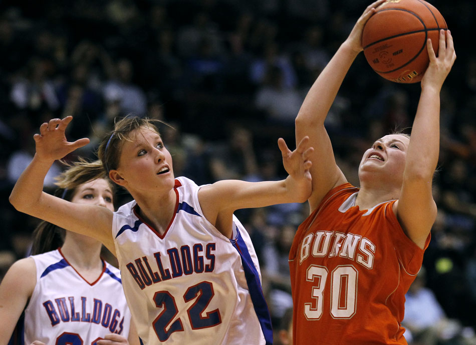 Burns' Becca Miller (30) goes in for a layup against Lovell's Leanne Winterholler (22) during the Class 2A championship game on Saturday, March 5, 2011, in Casper, Wyo.