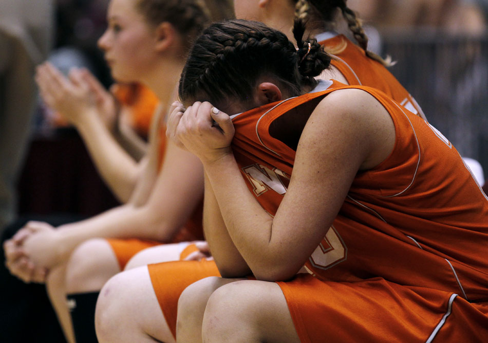 Burns' Bailey Ward puts her head into her jersey after being subbed out late in a Class 2A championship game loss to Lovell on Saturday, March 5, 2011, in Casper, Wyo.