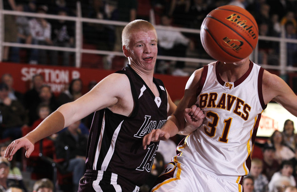 Laramie's Nick Moline (15) chases down a loose ball with Star Valley's Josh Hunsaker (31) during a Class 4A boy's basketball state tournament game on Thursday, March 10, 2011, in Casper, Wyo.