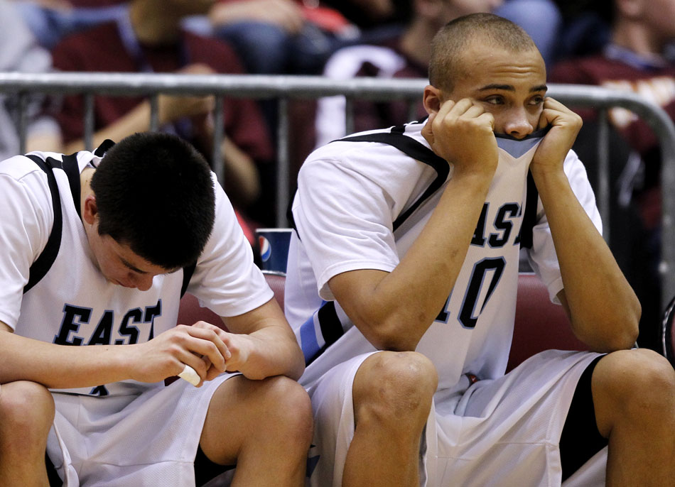 Cheyenne East's Derek Graves, right, watches from the bench with teammate Cameron Jaure during the closing minutes of a loss to Evanston in a Class 4A game in the state tournament fifth place bracket on Friday, March 11, 2011, in Casper, Wyo.