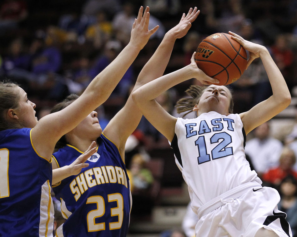 Cheyenne East's Sarah Erickson puts up a shot in front of Sheridan's Steph Sessions during a Class 4A girl's basketball semi-final on Friday, March 11, 2011, in Casper, Wyo.