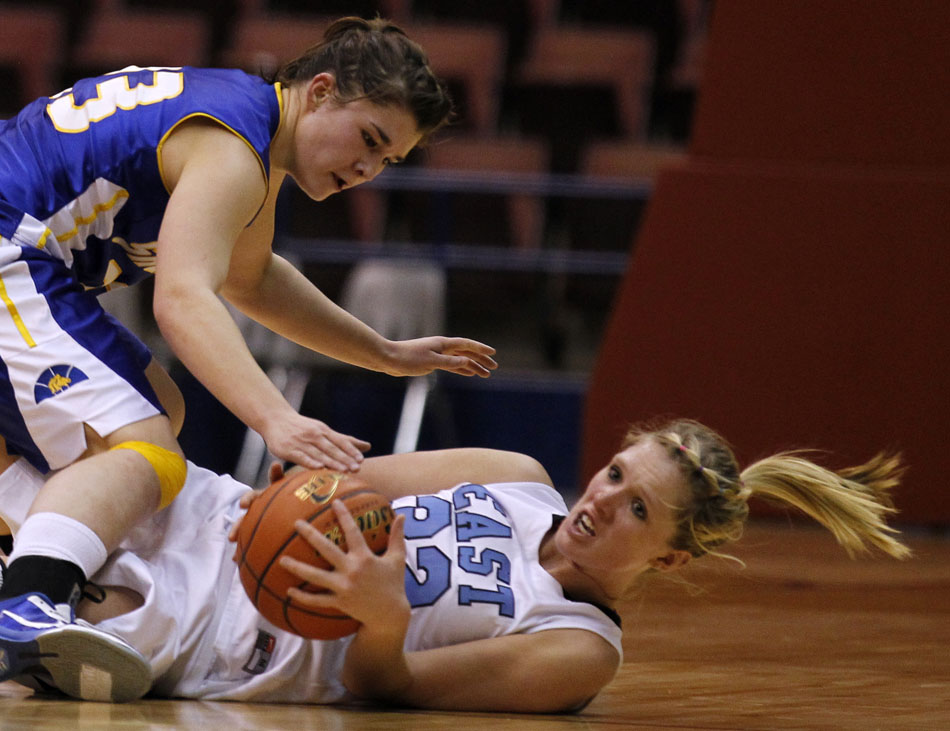 Cheyenne East's Meghan Sipe grabs a loose ball off the court as she's guarded by Sheridan's Steph Sessions during a Class 4A girl's basketball semi-final on Friday, March 11, 2011, in Casper, Wyo.