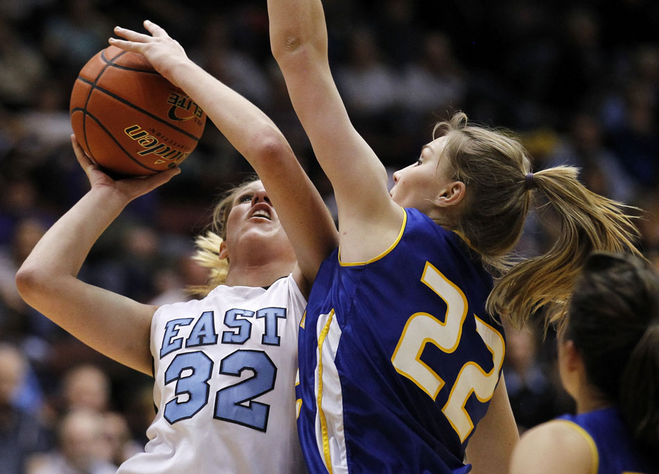 Cheyenne East's Meghan Sipe puts up a shot in front of Sheridan's Kayla Woodward during a Class 4A girl's basketball semi-final on Friday, March 11, 2011, in Casper, Wyo.