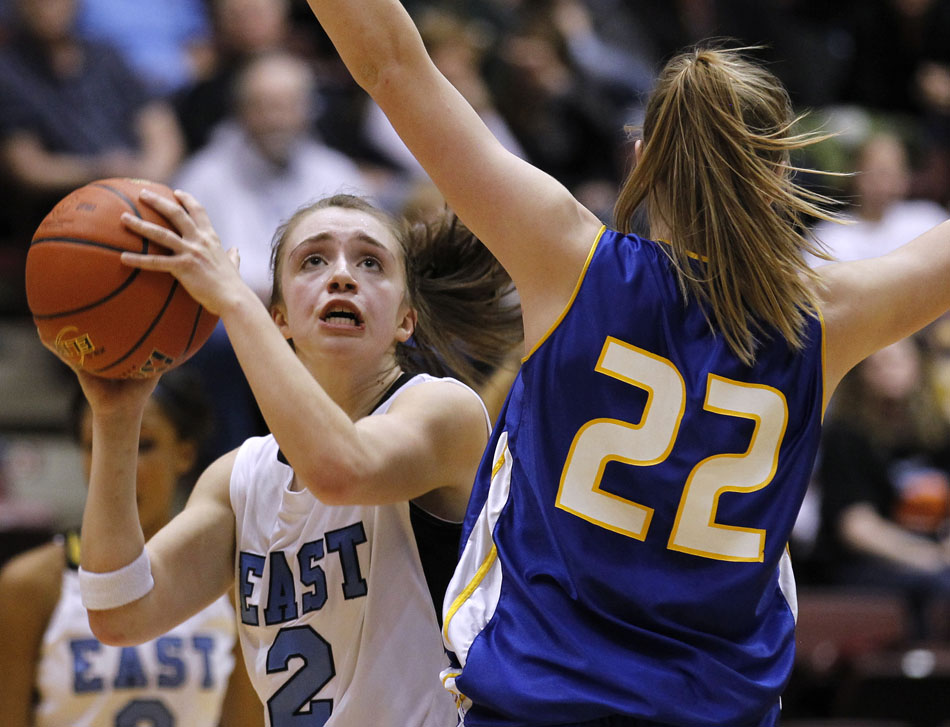 Cheyenne East's Savannah Minder looks to put up a shot in front of Sheridan's Kayla Woodward during a Class 4A girl's basketball semi-final on Friday, March 11, 2011, in Casper, Wyo.