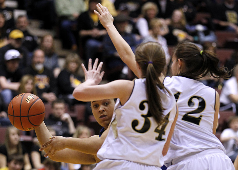 Wheatland's Breann Jackson makes a pass around Buffalo's Kinzi Litzel (34) and Leah Groteluschen during the Class 3A girl's basketball state championship game on Saturday, March 12, 2011, in Casper, Wyo.