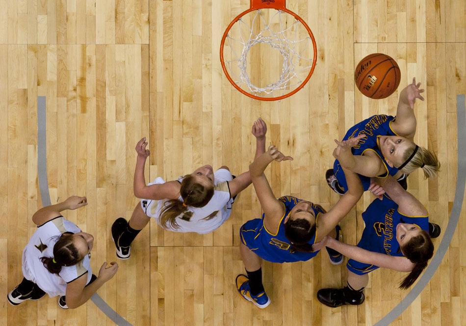 Wheatland's Shaya Irvine, top right, grabs a rebound during the first half of the Class 3A girl's basketball state championship game against Buffalo on Saturday, March 12, 2011, in Casper, Wyo.