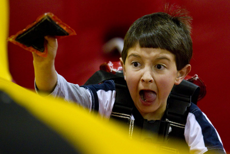 Derrick Hammer, 9, reacts as he stretches out to get some extra distance as he competes in the bungee run during a city-sponsored spring carnival on Wednesday, April 20, 2011, at the Cheyenne Ice and Events Center. The event featured numerous games and activities for youngsters.