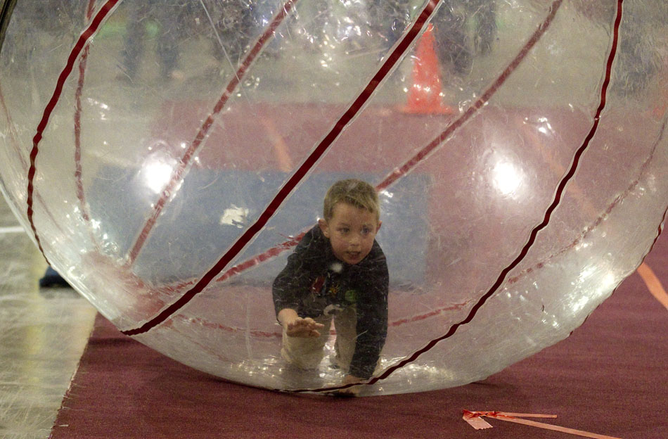 Casey Walters, 5, crawls as he competes in a race inside of a inflatable ball during the city-sponsored spring carnival on Wednesday, April 20, 2011, at the Cheyenne Ice and Events Center.
