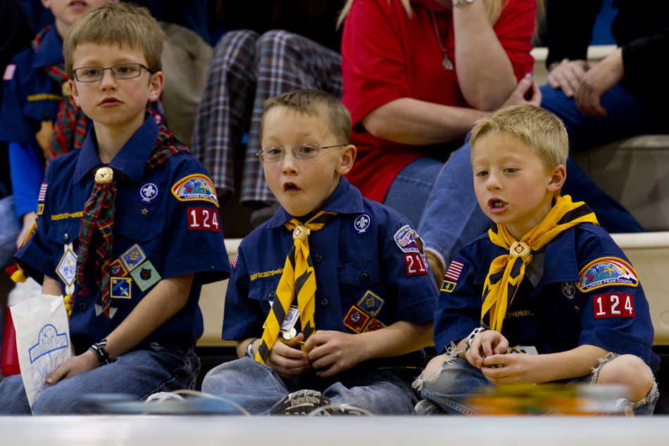 Cub Scout Riley Milburn, center, reacts as he watches a pinewood derby car zoom by with fellow scouts Nathan Broomfield, right, and Joshua Broomfield on Saturday, April 23, 2011, at Storey Gym.