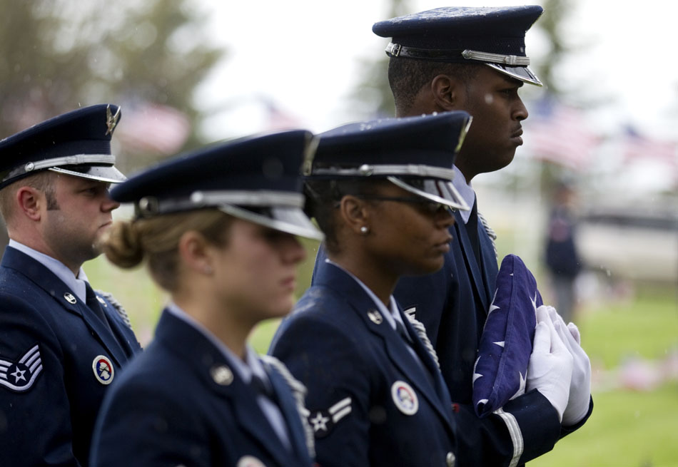 Members of the Warren Air Force Base color guard watch a Memorial Day ceremony on Monday, May 30, 2011, at Beth El Cemetery in Cheyenne.