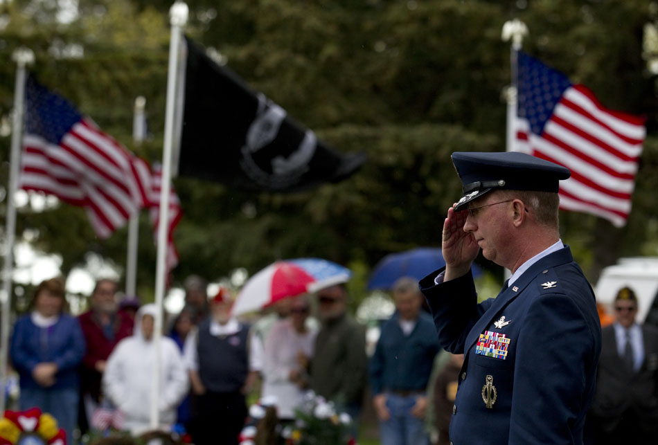 Col. Scott Fox, vice commander of the 90th Missile Wing at Warren Air Force Base, salutes after laying a wreath for the Air Force during a Memorial Day ceremony on Monday, May 30, 2011, at Beth El Cemetery in Cheyenne.