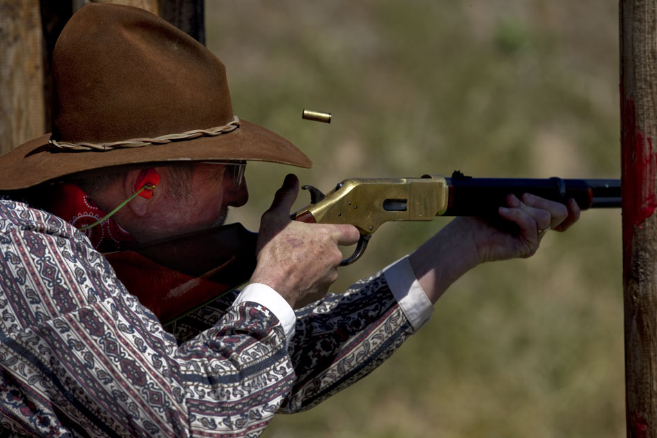 Bill Capozella, who depicts William Clarke Quantrill in the Cheyenne Regulators, fires a rifle at a target during a cowboy shooting competition on Saturday, June 4, 2011, at the range west of Cheyenne.