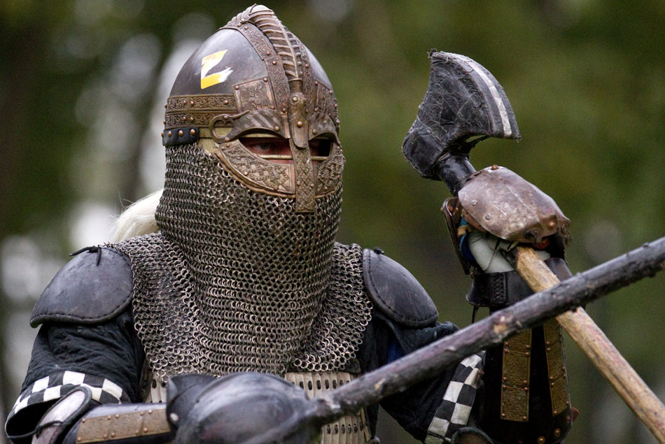 John Glidewell stares down his opponent as he prepares to strike during a fight practice for local members of the Society for Creative Anachronism on Wednesday, Aug. 31, 2011, in Holiday Park. Group members fight in medieval armor and are not allowed to use limbs after they are hit by a weapon.