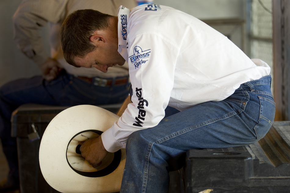 Bullrider Corey Navarre from Weatherford, Okla. prays behind the main chutes during the Cheyenne Frontier Days rodeo on Sunday, July 31, 2011, at Frontier Park.
