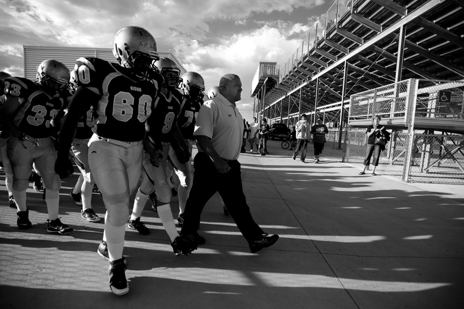 Cheyenne South coach Tracy Pugh leads his team onto the field before a Class 4A football game on Friday, Sept. 2, 2011, at Cheyenne South High School. Central won 63-0.